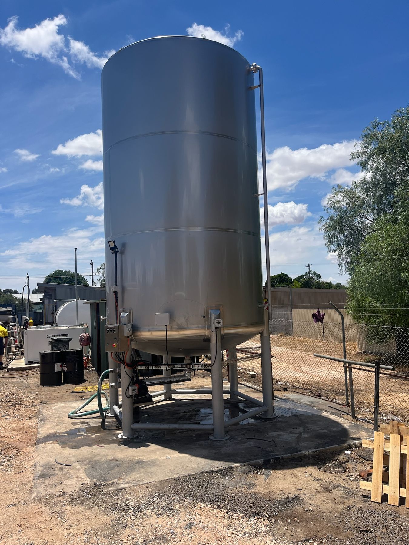 Stainless emulsion tank on a steel stand with control panel